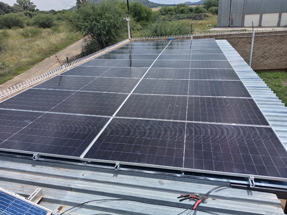 A large solar panel array mounted over a carport structure