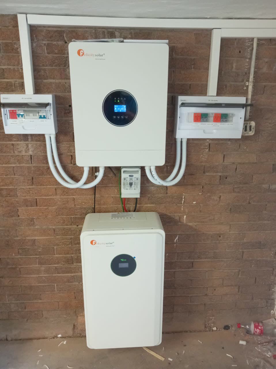 Solar inverter and battery mounted on a face-brick wall