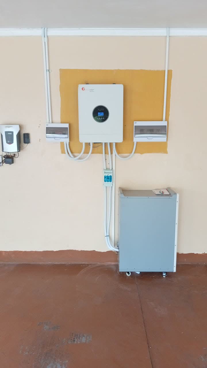 Solar inverter and battery installed on a wall beside a distribution board