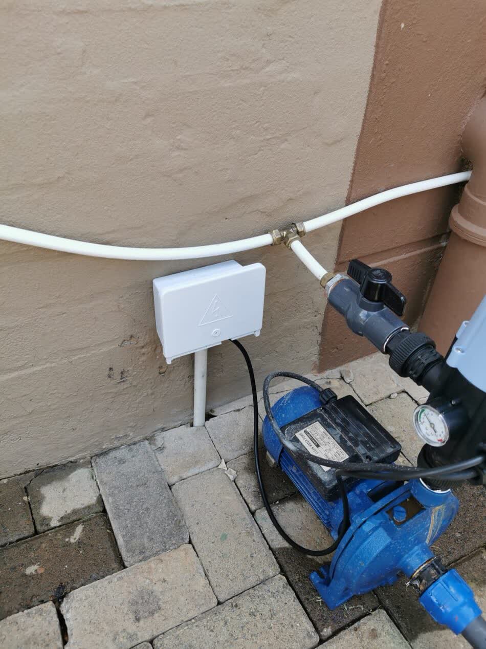 Pressure pump connected to plumbing with a weatherproof electrical connection box